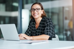 Woman using laptop smiling 