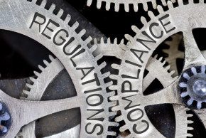 Cogwheel with the words regulations and compliance